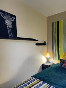 阿让塔*A setting between Dordogne and swimming pool*的卧室的墙上挂着长颈鹿照片