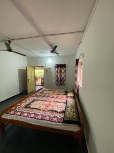 达博利Aviraj Nivas的地板上铺着地毯的房间的一张床位