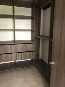 Elegante apartamento en condominio cerca del aeropuerto的衣柜配有木制架子和窗户