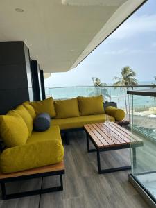 Sere KundaFar Out Apartments - Kololi Sands的客厅配有黄色的沙发和桌子