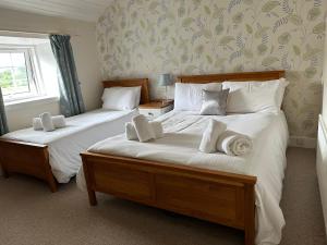 斯特朗申斯特朗廷酒店的一间卧室配有两张带白色床单的床