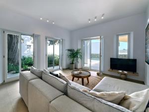 莫罗斯帕罗Private Luxury Scarlet beachfront villa, Molos, Paros的带沙发和电视的客厅