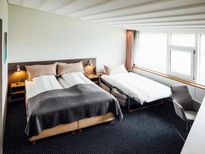托尔斯港佛洛雅酒店的一间卧室设有两张床和窗户。