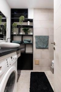 巴亚马雷Ultra central apartment的洗衣房配有水槽和洗衣机
