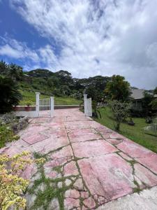 乌图罗阿Rupe Rupe Lodge的一条石头人行道,在院子里有白色的围栏