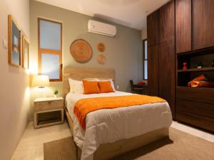 圣何塞德尔卡沃Carmensita的一间卧室配有一张带橙色毯子的床