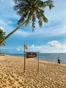 富国槟城侨海滩度假酒店的棕榈树海滩上的标志