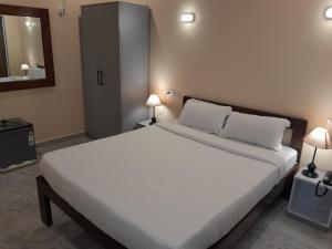 MaemDE RUSH FARM的一间卧室配有一张带两盏灯的大型白色床。