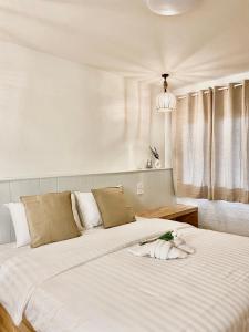 格兰岛The O room的一间卧室配有两张带白色床单的床