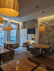 波尔图Oportoflag center的一间带桌椅和石墙的餐厅
