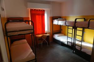 里米尼Sunflower City Student Hostel & Bar的客房设有三张双层床和一扇窗户。