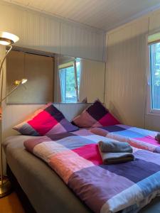 圣戈阿尔Hausboot im Hafen的一间卧室配有两张带色彩缤纷枕头的床。