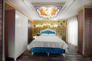伊斯坦布尔巴贝尔公园酒店的一间卧室配有一张大床和蓝色床头板
