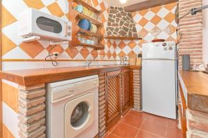 弗里希利亚纳Casita Frigiliana的厨房配有洗衣机和微波炉。