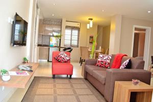 阿克拉Acquah Place Residences的带沙发和红色椅子的客厅
