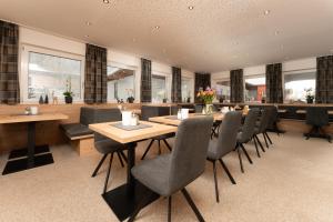 索尔登阳光家庭旅馆的用餐室配有木桌和椅子