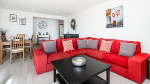 维拉摩拉Vilamoura - Spacious with Swimming Pool & View的客厅里一张红色的沙发,配有桌子