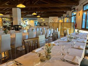 MercalloAquasole的用餐室配有长桌子和白色椅子