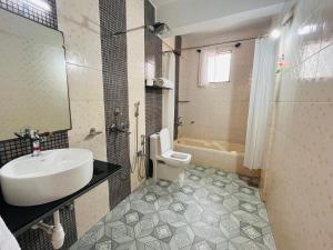 莫尔吉姆Nagas Hotel Satyavati Morjim的浴室配有盥洗盆、卫生间和浴缸。