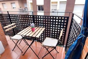 Santa Coloma de GramanetBravaholidays-831-Fabra-Barcelona的阳台上配有一张木桌和两把椅子