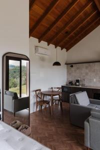 本图贡萨尔维斯Cabanas Vinsanto的厨房以及带桌子和沙发的客厅。