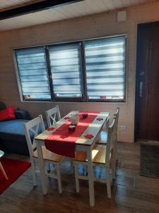 巴利格鲁德DOMKI RODIS的餐桌和椅子,配有红色桌布