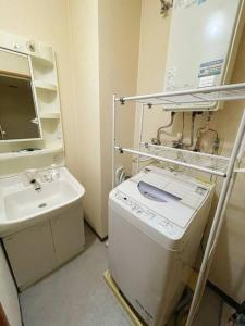 札幌中島公園徒歩3分、Susukino（薄野）内、格安有料駐車場あり(205号室）的小型浴室设有洗衣机和水槽。