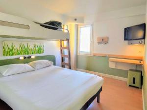 土伦Ibis Budget Toulon Centre的一间卧室配有双层床和电视。
