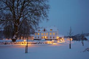 瓦埃勒哈拉德斯卡辛那图尔酒店及会议中心的雪中带圣诞灯的大白色房子