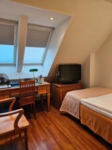 奥卢阿波罗贝斯特韦斯特酒店的一间卧室配有两张床、一张桌子和一台电视。
