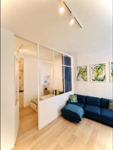 蒙彼利埃Suite Bayle - Standing - Hyper centre的一间带蓝色沙发的客厅和一间卧室