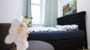 维也纳Modern Double room JS的一间卧室配有一张床、一张沙发和一个窗口