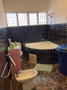 LabattoirL’escale petite terre的带浴缸、卫生间和盥洗盆的浴室