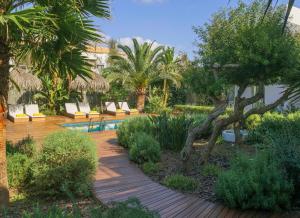 埃斯卡洛Es Caló Luxe - Formentera Break的一个带椅子和树木的花园以及游泳池