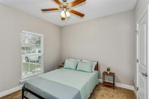 彭萨科拉Lovely Town-home in Pensacola的一间卧室配有一张床和吊扇
