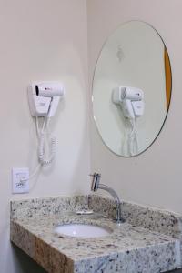 大瓦尔泽亚Hotel Fly - Aeroporto Cuiabá的一间带水槽和镜子的浴室