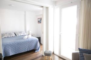 利马Barranco Best Location - Apartment的一间卧室设有一张床和一个大窗户