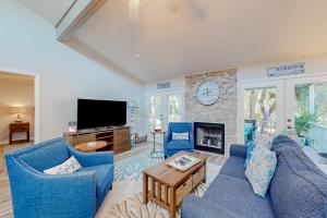 圣奥古斯丁The Harbour Home的客厅设有蓝色的沙发和壁炉