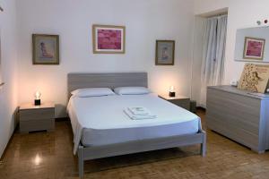 布雷西亚FiorDiLuna, nel cuore di Brescia的卧室配有白色的床和2个床头柜