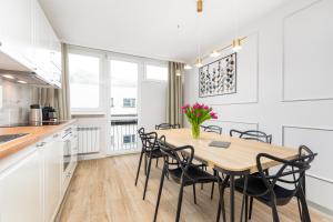华沙Apartament Grzybowska Premium by Your Freedom的厨房以及带木桌和椅子的用餐室。