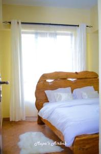 NyahururuMupa's Luxury Condo II的一间卧室设有一张大床和大窗户