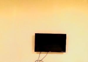 JālgaonHotel Kewal INN Jalgaon的挂在墙上的平面电视