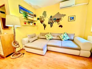 布达佩斯Benett apartman的客厅配有沙发,墙上挂着世界地图