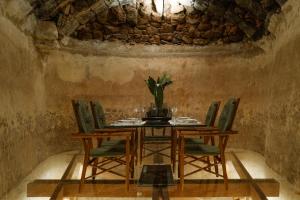 阿索马达Hotel Cesar Lanzarote的一间设有桌椅和石墙的用餐室
