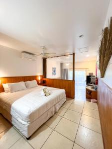 拉罗汤加流浪者度假酒店的卧室配有一张白色大床