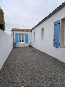 La BétaudièreMaison de vacances récente的白色的房子,有蓝色的门和车道