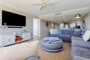 奥蒙德海滩Paloma Penthouse的客厅配有蓝色的家具和平面电视。