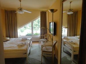 奥斯拉瓦河畔纳梅什季摩纳哥酒店的一间卧室配有两张床、一张桌子和一面镜子