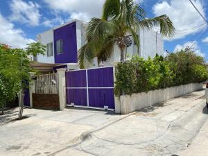 Santa AnitaOasis Casa 120的一座带紫色大门和棕榈树的房子