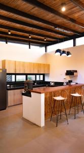 维加伊托Wiro House - Casa de Playa en Vichayito的厨房配有柜台和凳子